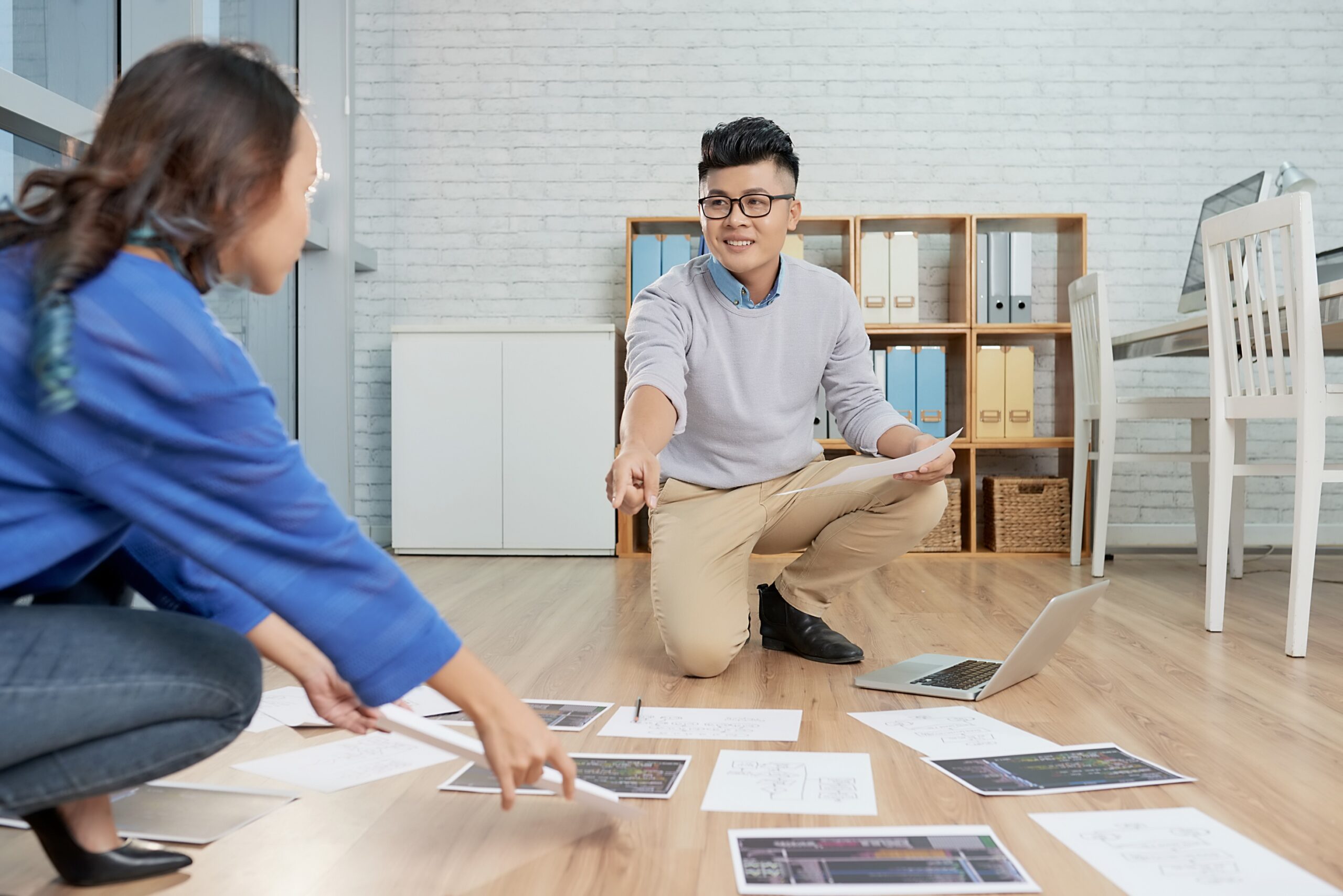 Interior designer collaborating with office furniture supplier on workspace planning